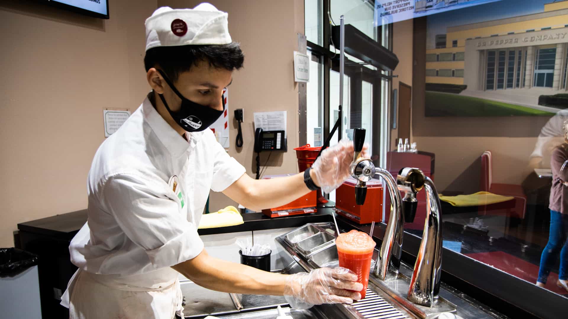 soda jerk making a big red float