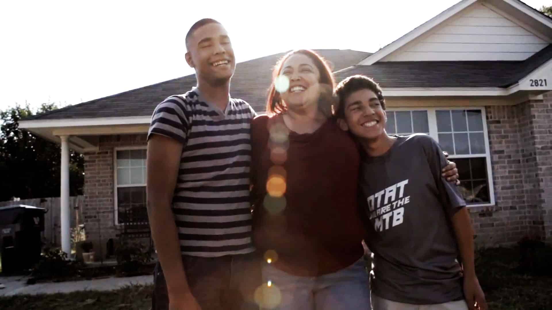 family in front of their home